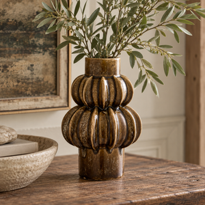 Orsa Brown Stoneware Bubble Vase with its glossy, stacked ribbed form, styled in a warm, neutral interior.