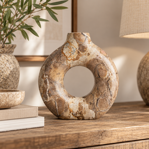 Ossa Chocolate Marble Candle Holder, a round chocolate and cream marble candle holder styled on a rustic wooden console table.