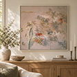 Phantom Lily painting in a white float frame above a wooden sideboard with a stone vase of olive branches and brass candlesticks