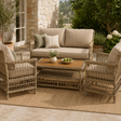 Outdoor patio set with wicker chairs and sofa on a stone patio.