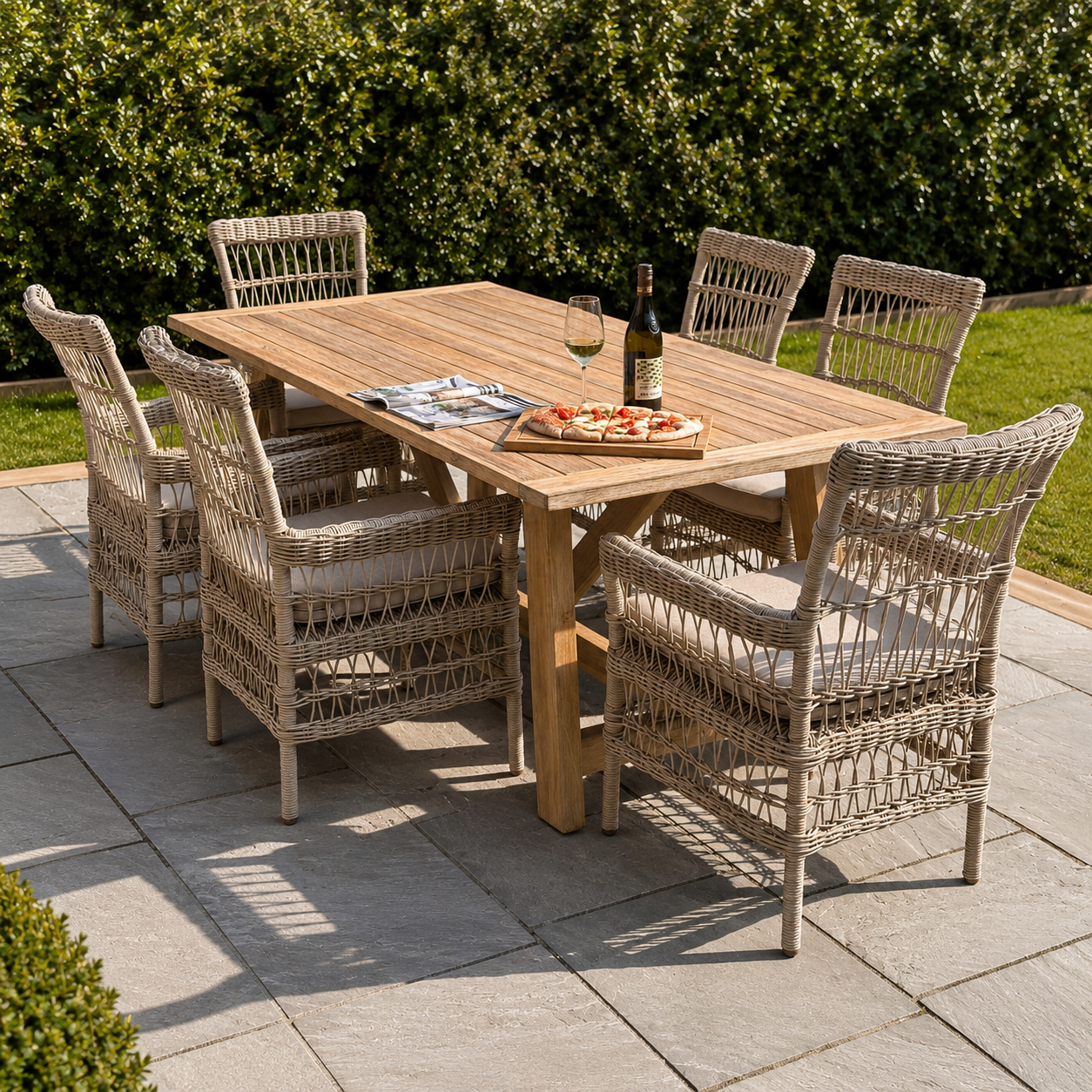 Outdoor dining setup with a wooden table and wicker chairs on a patio.