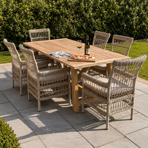 Outdoor dining setup with a wooden table and wicker chairs on a patio.