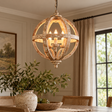 Solara Orb Pendant Ceiling Light lit above a dining table