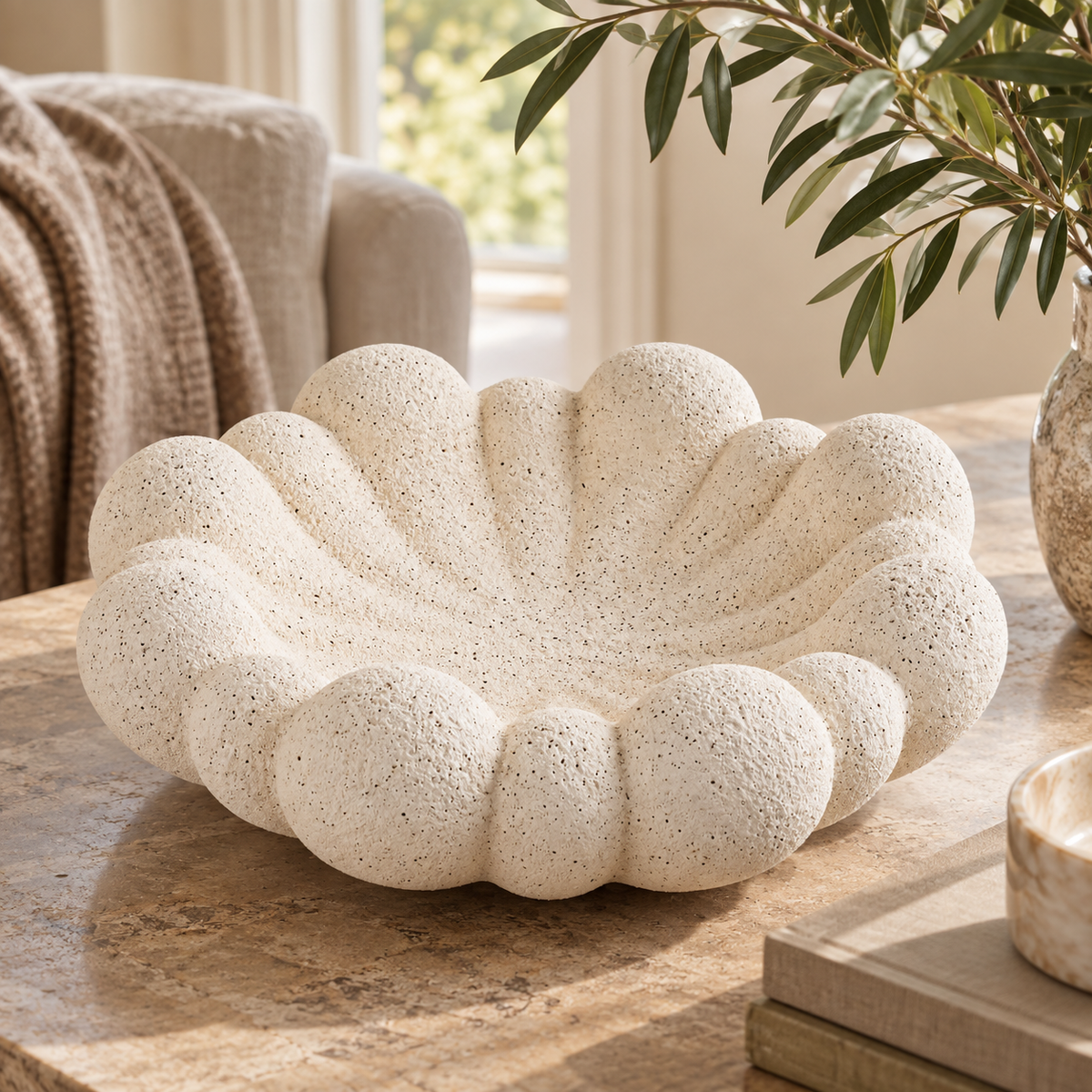Soren Sandstone Effect Bubble Design Bowl styled on a natural stone table in a warm, neutral living room.