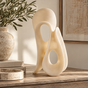 Soren White Marble Effect Large Abstract Loop Sculpture styled on a rustic wooden console table with neutral décor, olive branches, books and a travertine dish.