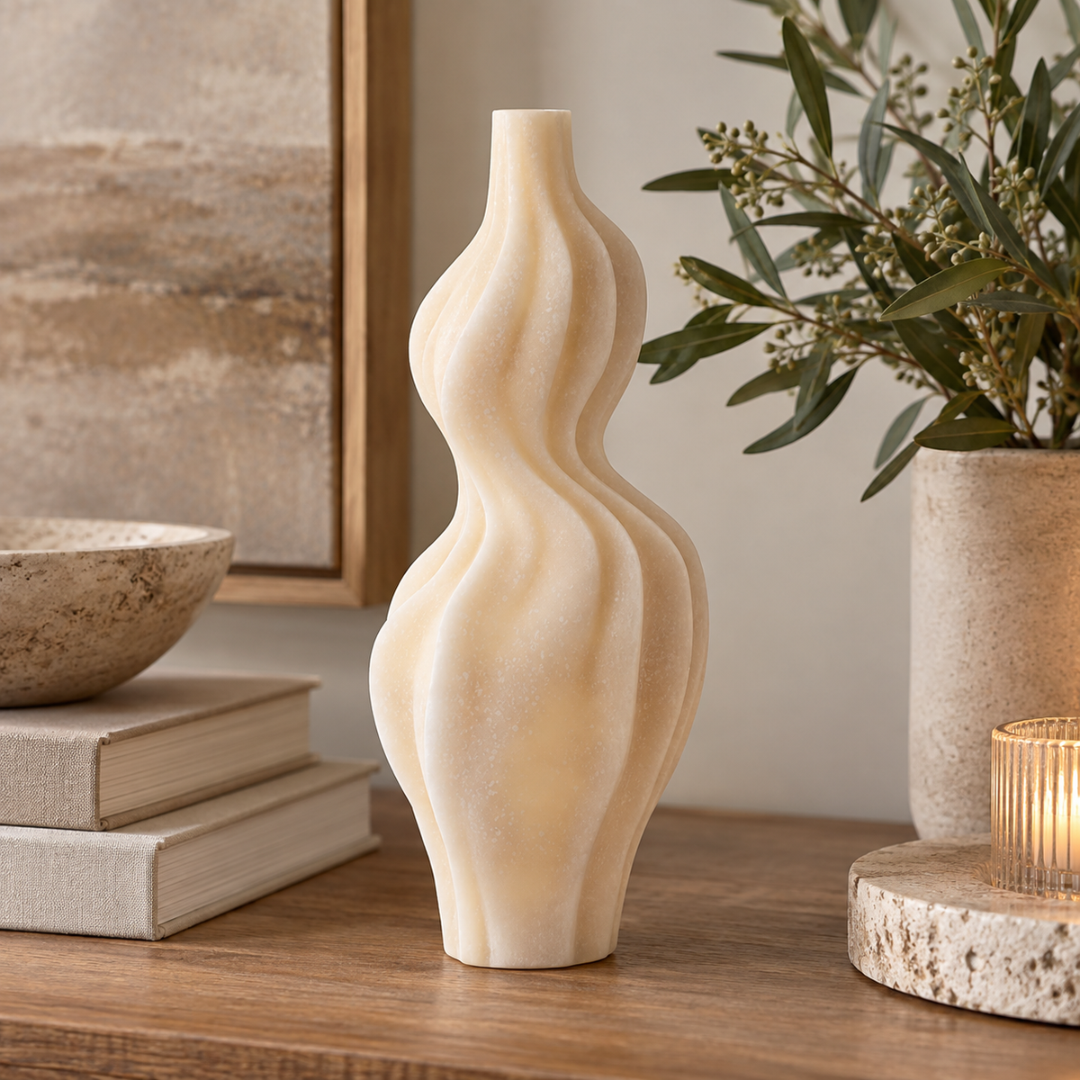 Soren White Marble Effect Organic Twist Ornament with flowing curved ridges, styled on a warm wooden table with neutral décor and greenery.