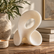 Soren White Marble Effect Small Abstract Loop Sculpture with a rounded loop design, styled on a rustic wooden table with neutral décor and greenery.