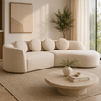 Sorena three seater cream linen sofa in a neutral room with a plant and a coffee table and decor items