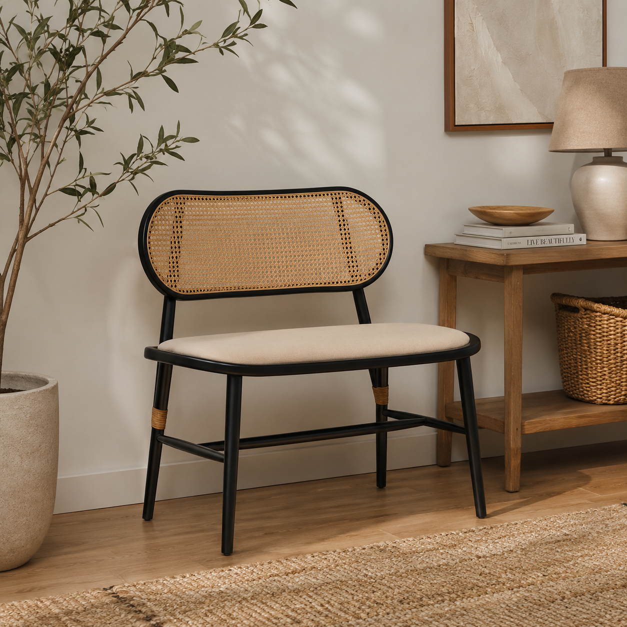 Wicker chair with black frame in a room with wooden side table and plant