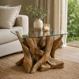 Glass coffee table with teak tree root base in a living room setting