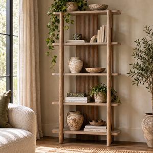 The Hawthorn Five Tier Grey Mango Wood Shelf Unit styled with books, stoneware pots, bowls and trailing plants beside a window in a sunlit living room.