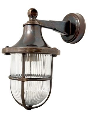 Bronze outdoor wall light fixture with clear glass shade on a white background