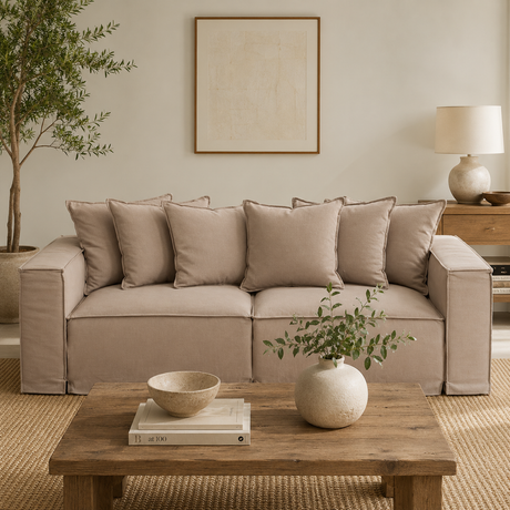 Versailles three seater grey sofa in a living room with a rustic wooden coffee table and decorative accessories
