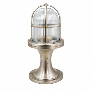 A marine navigation light fixture with a ribbed clear glass dome and a brushed silver metal base and cage, shown on a solid white background.