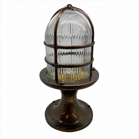 Industrial nautical light fixture with a ribbed clear glass dome and a bronze-finished metal cage and base, shown on a white background.