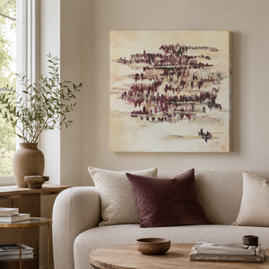 Living room with a beige sofa, abstract painting, and decorative items.
