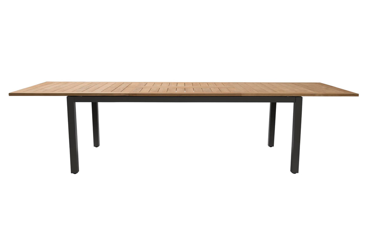 A rectangular outdoor dining table with a light brown teak wood slatted top and a black metal frame with four legs, shown against a plain white background.