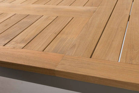 Close-up of a light natural wood slatted surface with a thick matching wooden frame or trim along the bottom edge.
