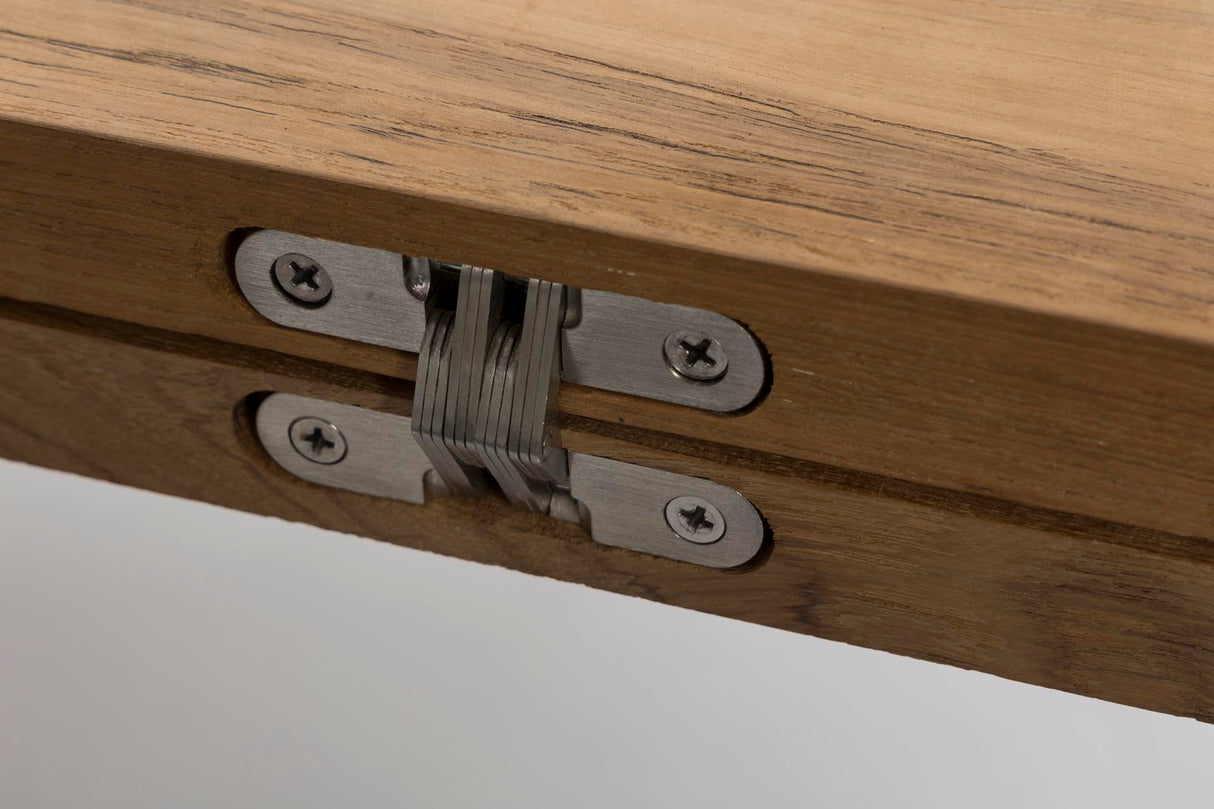 Close-up of a metal tension latch mechanism attached to a light brown wooden frame, secured with screws.