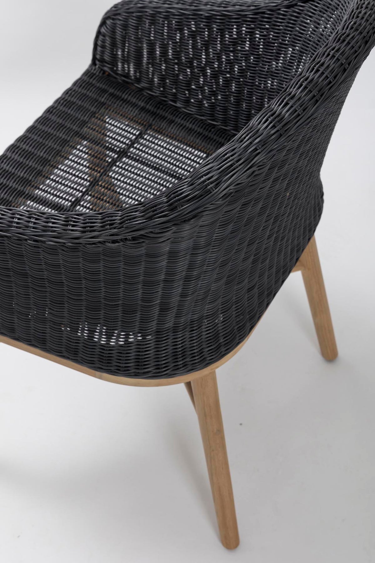 Dark grey woven chair with wooden legs on a white background