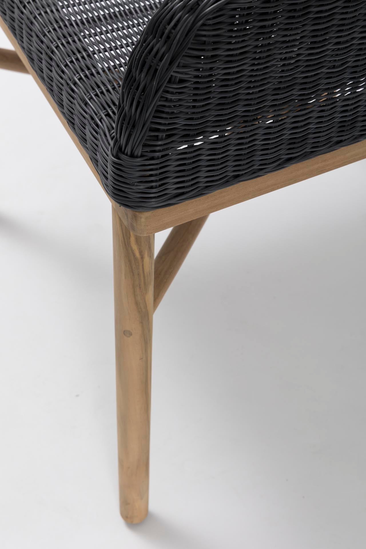 Close-up of a chair with woven backrest and wooden legs on a white background