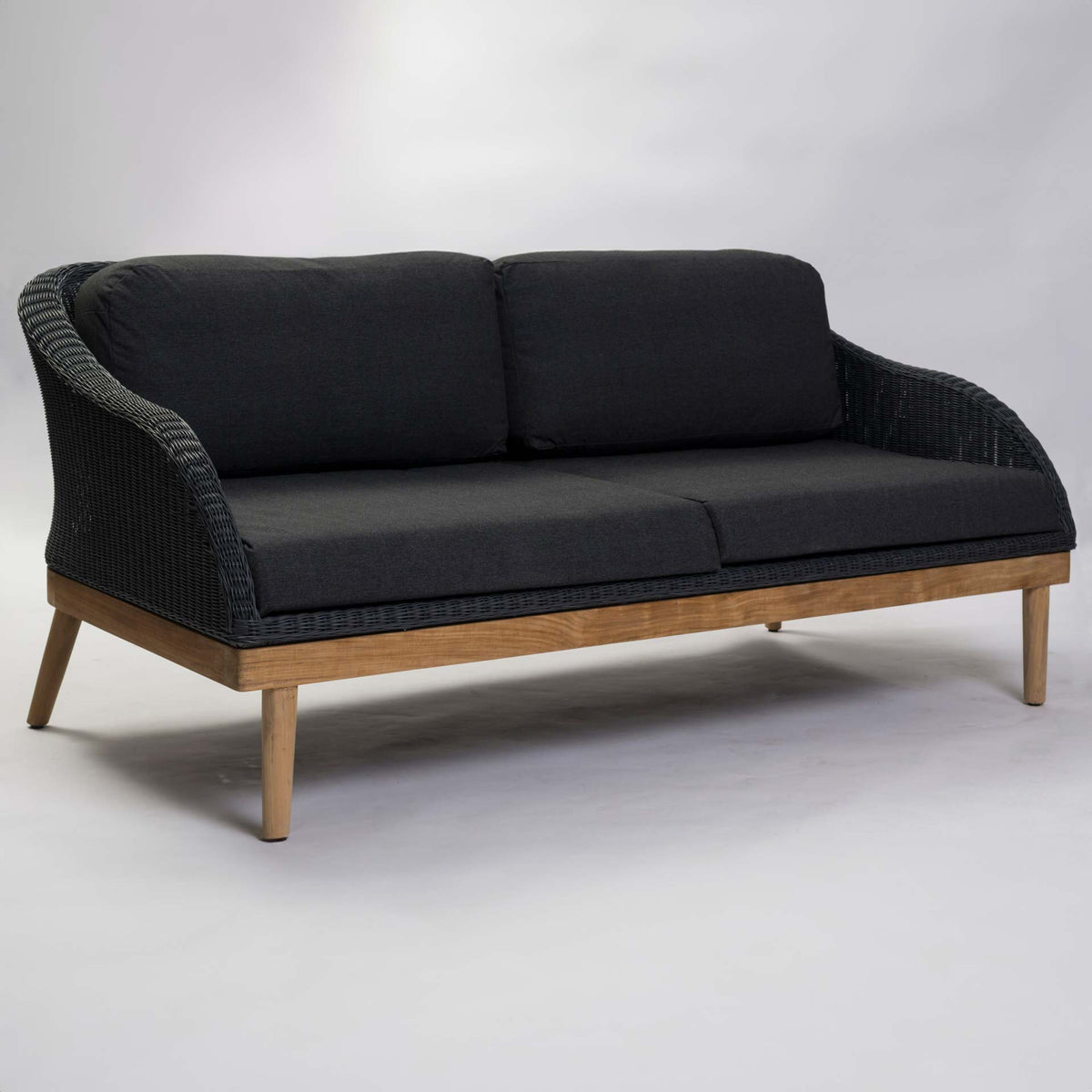 Large dark grey outdoor sofa with wooden frame on a grey background