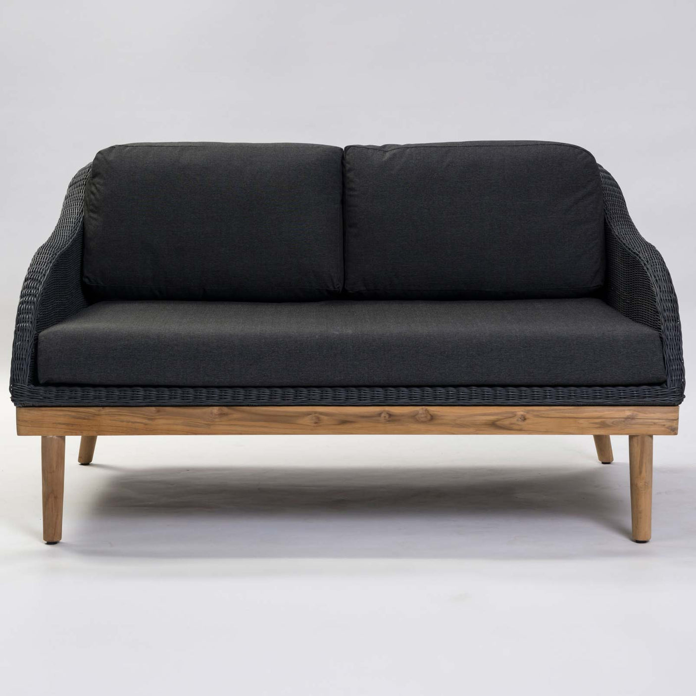Dark grey wicker sofa with wooden frame on a white background