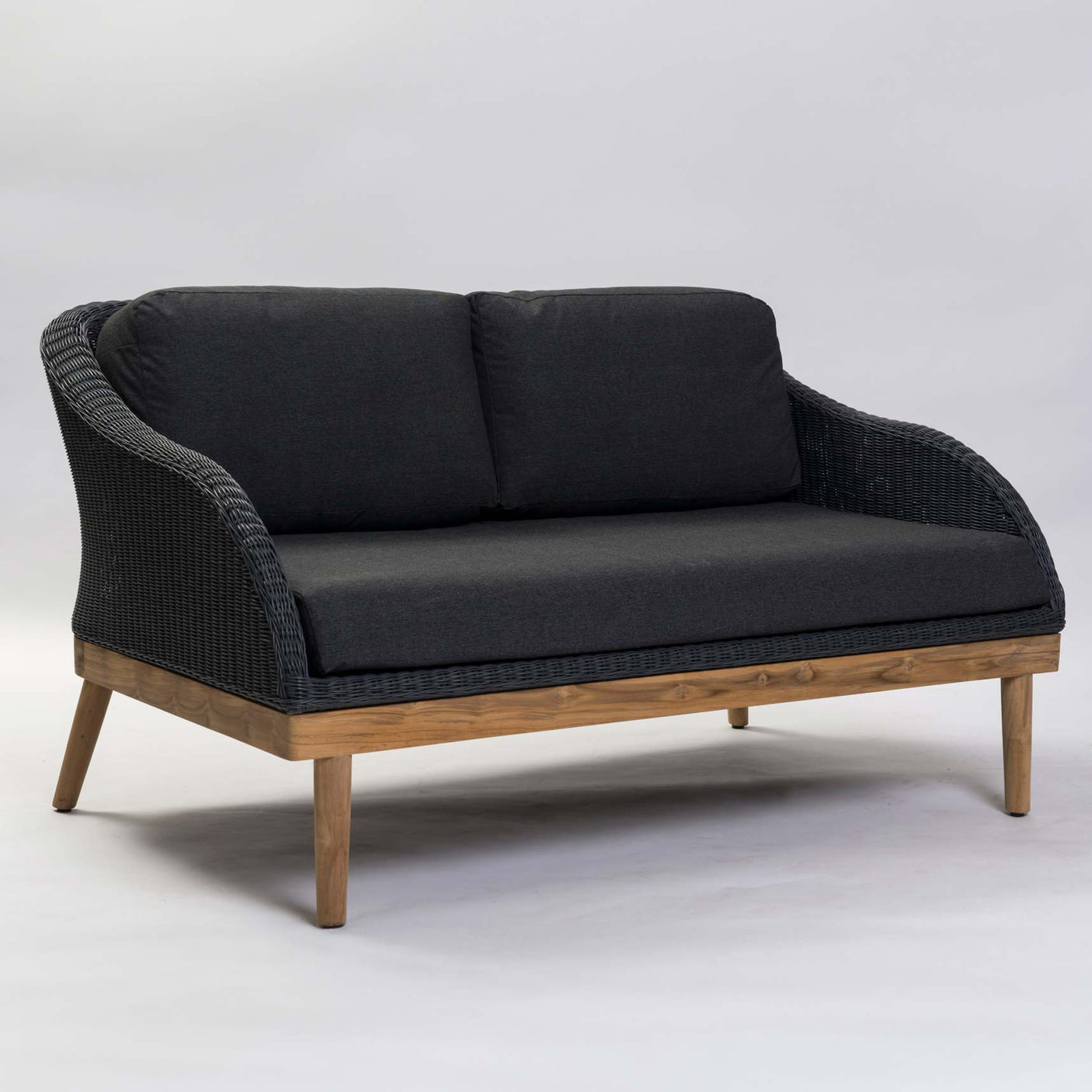 Dark grey cushioned sofa with wooden frame on a light grey background
