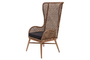 A tall, high-back woven rattan dining chair with a dark charcoal cushion on the seat and light brown wooden legs, shown against a plain white background.