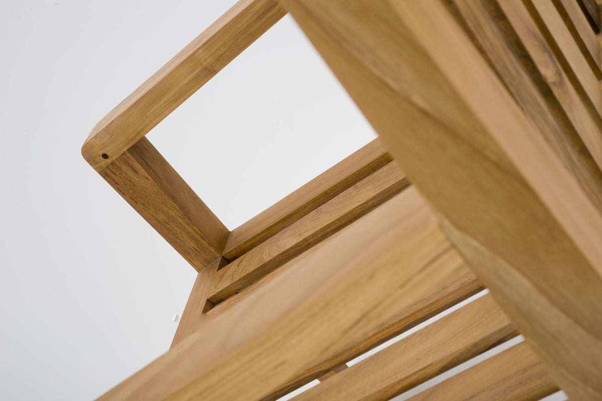 Close-up of a light natural wood slatted chair, showing the corner joint and slatted back against a plain white background.