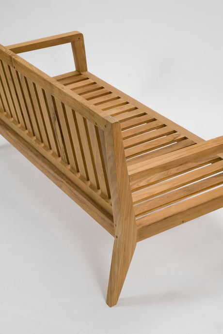 A light natural wood slatted bench with a slatted backrest and angled legs, photographed on a clean white studio background.