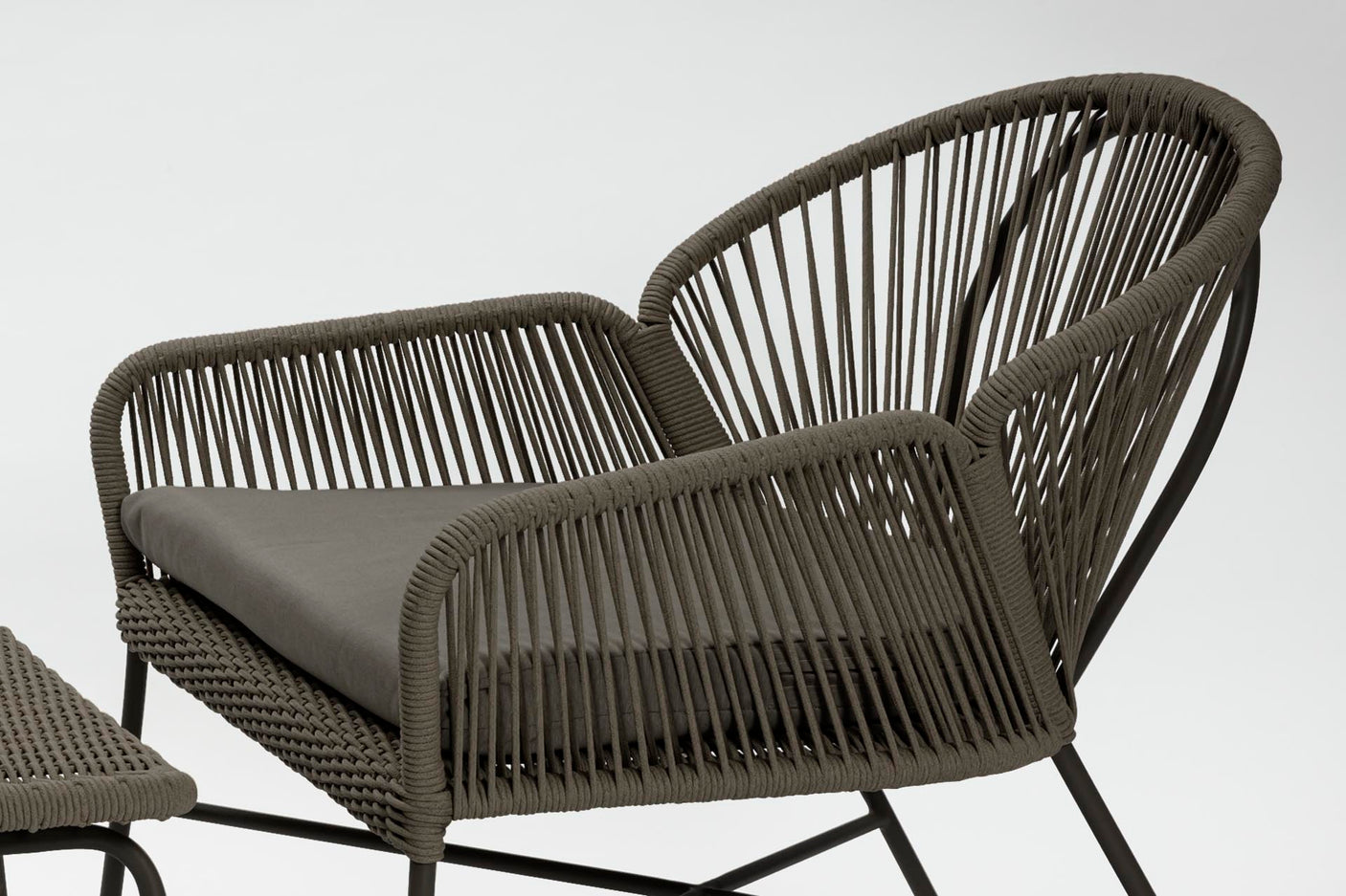 Woven chair with cushion on a white background