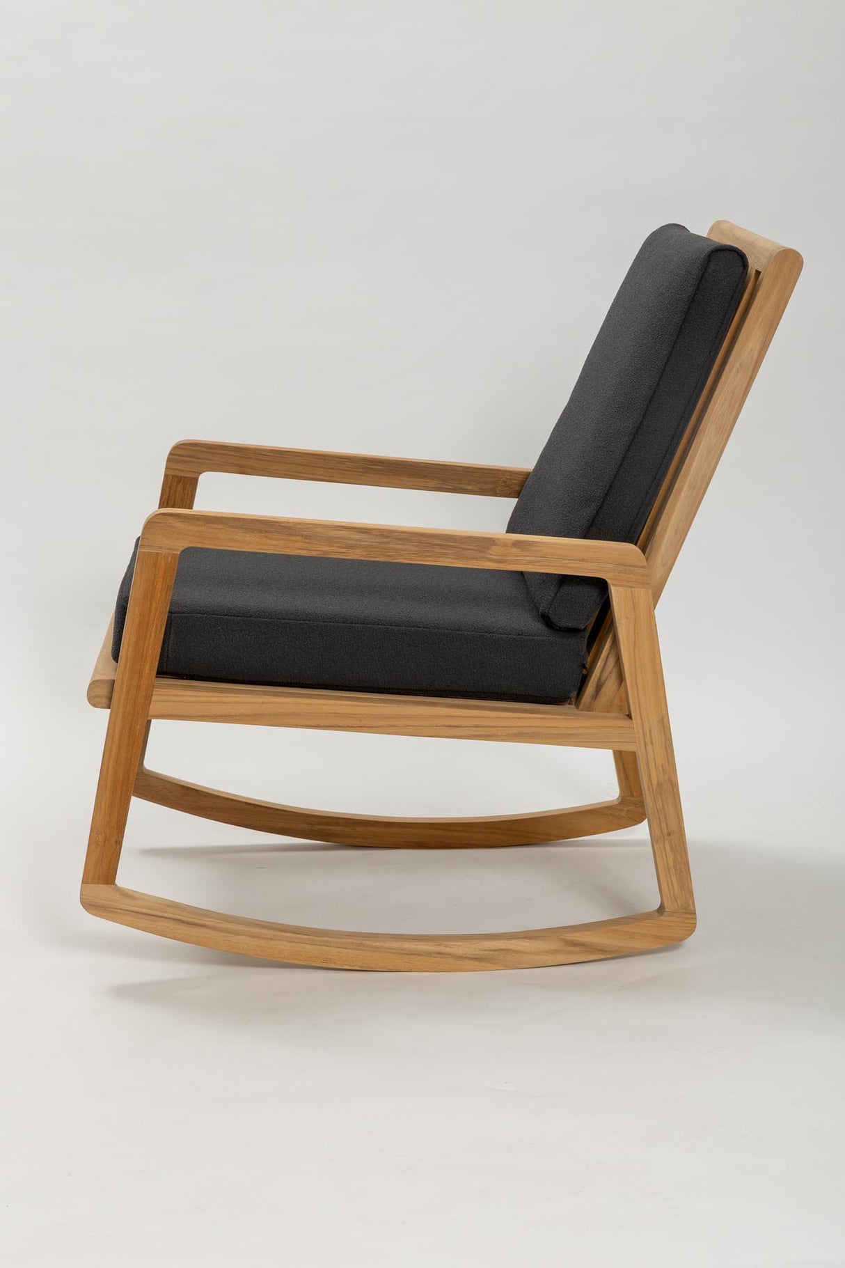 Wooden rocking chair with black cushions on a white background