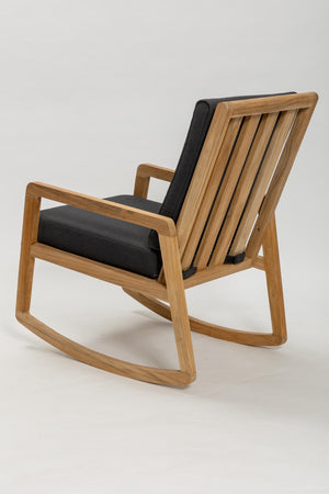 Wooden rocking chair with black cushions on a white background