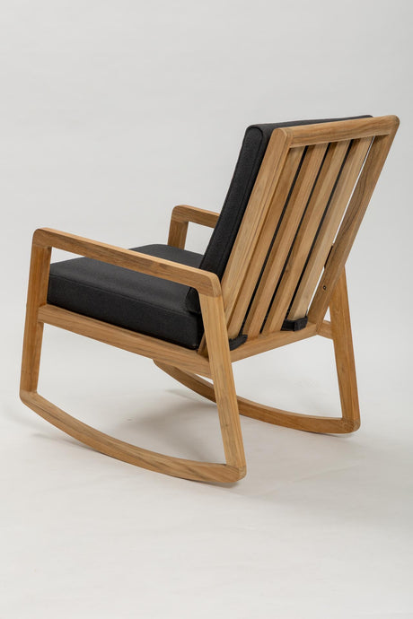 Wooden rocking chair with black cushions on a white background