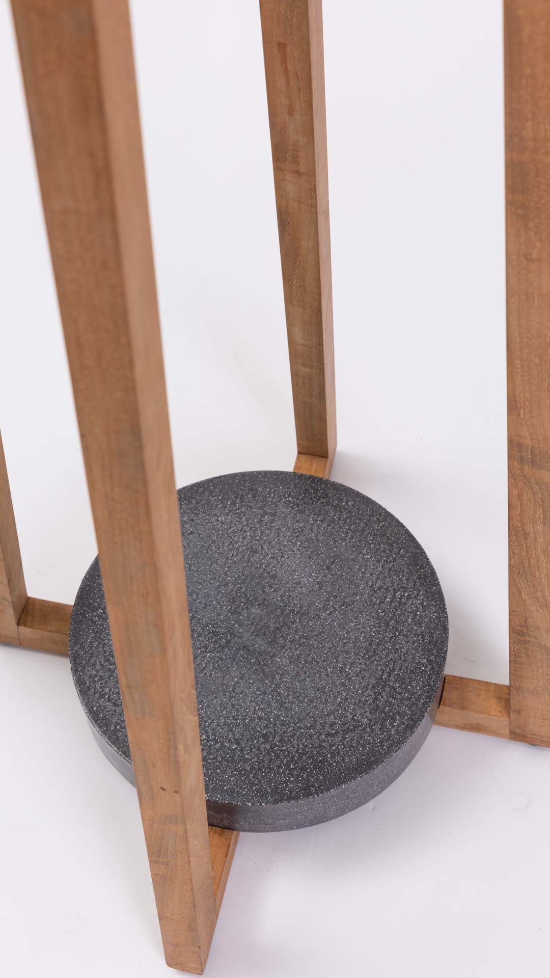 Close up of the base of an outdoor floor lamp on a white background.