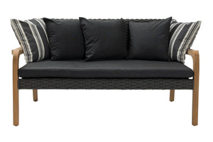 A modern outdoor loveseat with a dark gray woven wicker frame, black seat and back cushions, and light brown wooden legs. It features four throw pillows, including two black pillows and two striped black-and-white pillows, shown against a plain white background.