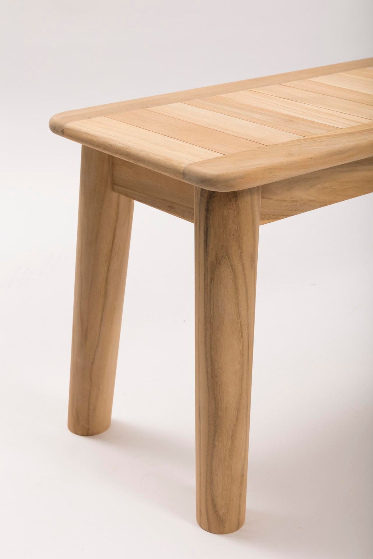 Outdoor wooden bench with a light finish on a white background