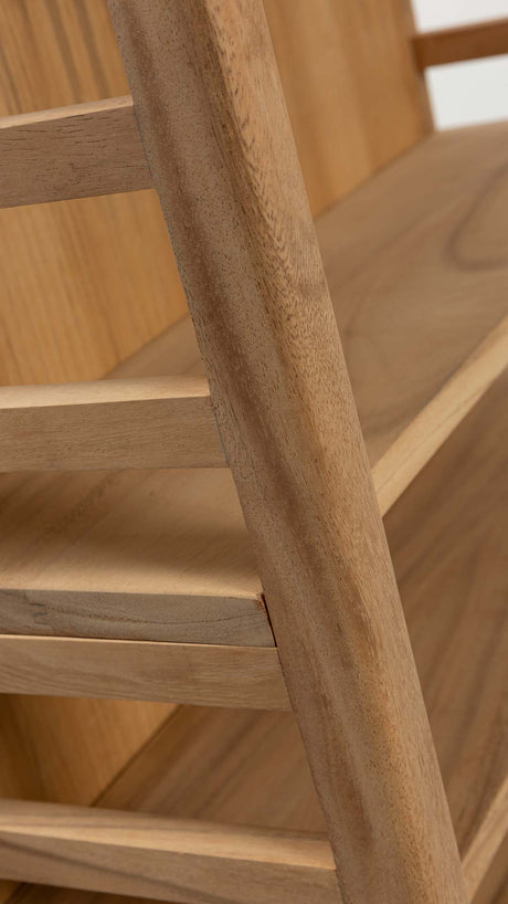 Close-up detail of a light natural wood furniture piece, showing the grain and layered slatted structure.