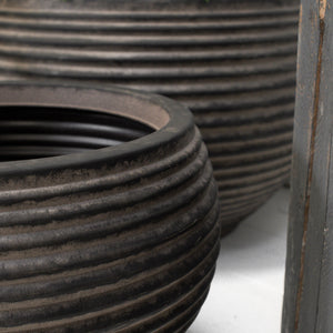 Close up of two dark brown ribbed planters