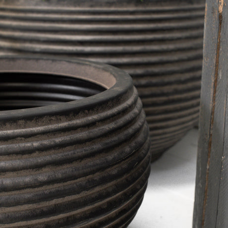 Close up of two dark brown ribbed planters