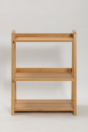 A three-tier wooden bookshelf with a natural oak finish, shown against a plain light gray background.