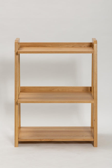 A three-tier wooden bookshelf with a natural oak finish, shown against a plain light gray background.